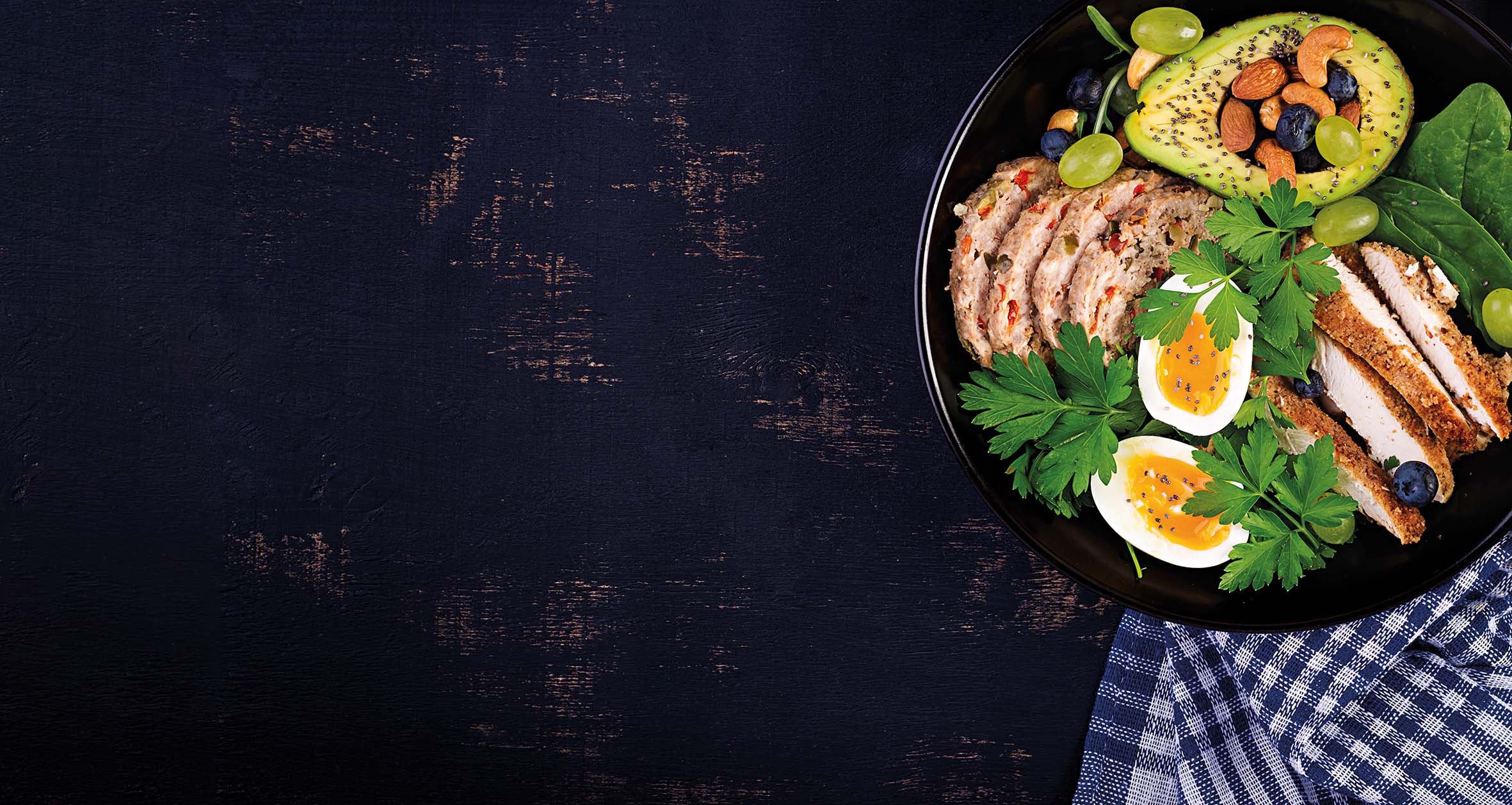 Ketogenic diet. Buddha bowl dish with meatloaf, chicken meat, avocado, berries and nuts. Detox and healthy concept. Keto food. Overhead, top view, flat lay