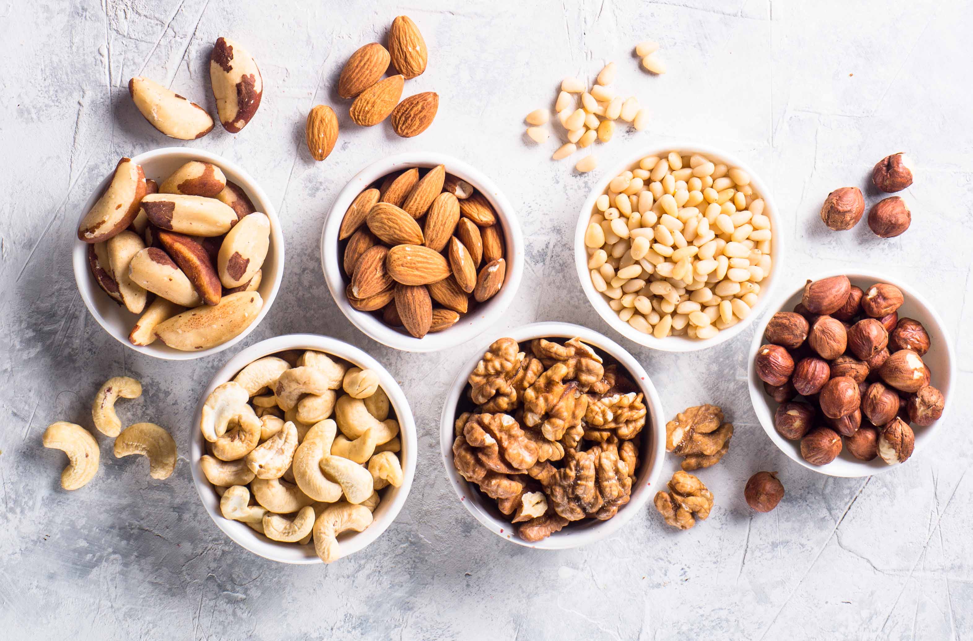 Nuts assortments on stone table top view.